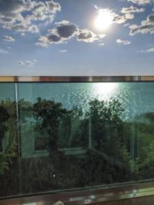 a view of the ocean from a glass window at Mamaia centru Kids friendly apartament in Mamaia