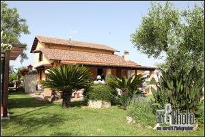 a house with a garden in front of it at Casale Del Borgo in Hermada