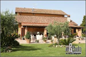 a house with a table and chairs in a yard at Casale Del Borgo in Hermada