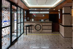 a lobby with a counter in a building with stained glass at Best Western Hotel Plaza Matamoros in Matamoros