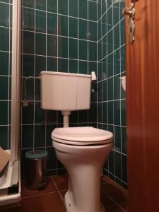 
a white toilet sitting in a bathroom next to a sink at Haus Franziska in Leck
