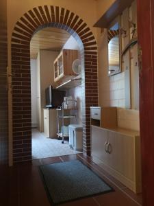 a kitchen with a brick archway in a room at Haus Franziska in Leck