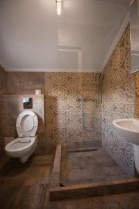 a bathroom with a toilet and a sink at Vila Yanis Vama Veche in Vama Veche +36 photos