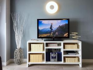 a flat screen tv sitting on a white entertainment center at Mesa del Mar Sunset Dream vacational rental home in Puerto de la Madera