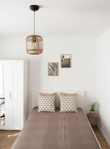 a bedroom with a large bed with two pillows at Dom Latarnika in Jarosławiec