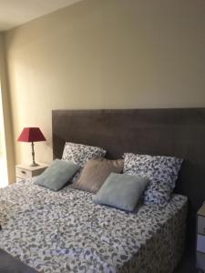 - une chambre avec un lit et des oreillers dans l'établissement Un jardin en ville, à Sarlat-la-Canéda
