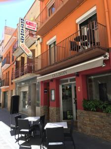 ein Restaurant mit Tischen und Stühlen vor einem Gebäude in der Unterkunft Pequeño loft para dos in Sant Feliu de Guixols