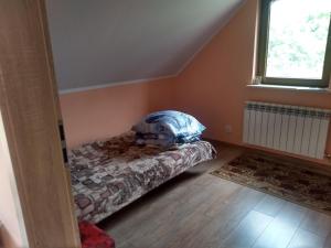 a bedroom with a bed and a window at Zacisze nad Rospudą in Filipów