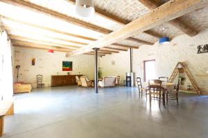 a large room with a table and chairs in it at Mas du Cres Gîte in Galargues
