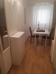 a small room with a table and a table and chairs at Apartments Petra 23 in Mali Lošinj