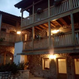 a large stone building with a large balcony at Romantic Boutique Hospitality in Revine Lago