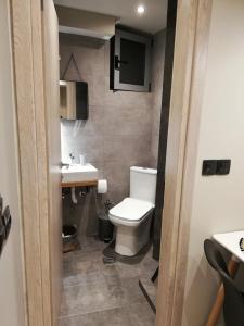 a bathroom with a white toilet and a sink at Dolora's in Methana +74 photos