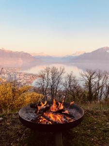 a fire pit with a view of a city at Lovely villa in Lavaux with unique view ! in Chardonne
