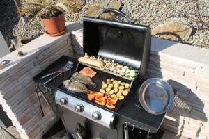 a grill with a bunch of food on it at Villa Toscana in Steyr