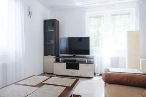 a living room with a flat screen tv on a entertainment center at Villa Melody in Bohinj
