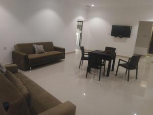 a living room with a couch and a table at Ras Alkhyran Resort عائلات فقط in An Nāmī