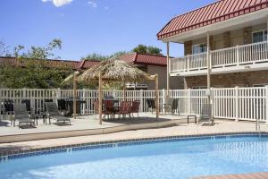 a pool with chairs and a table and a house at Montrose Valley Lodge in Montrose