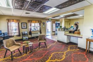 a woman standing at a counter in a hotel lobby at Montrose Valley Lodge in Montrose +50 photos