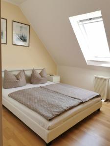 a bedroom with a bed with a large window at Ferienhaus am Darß in Pruchten