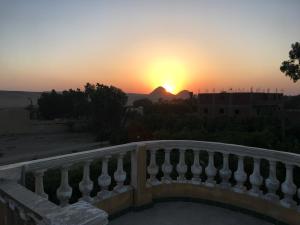 a sunset seen from the balcony of a building at Sakkara Inn in Cairo