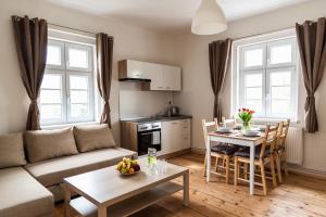 a living room with a couch and a table at Penzion U Pivovaru in Děčín
