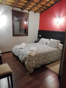 Un dormitorio con una cama con dos toallas encima. en EL MOLINO, en Sequeros