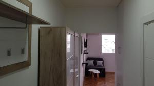 a room with a hallway with a table and a chair at CENTRAL VIEW APARTMENT in Skopje