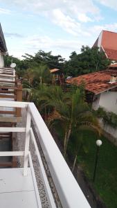 a view from the balcony of a house with palm trees at Apto Aconchegante Enseada Azul com Wi-Fi in Guarapari