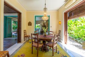a dining room with a table and chairs at Villa Angsa by Nakula in Sanur