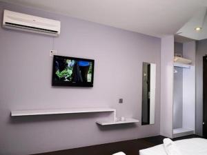 
a bathroom with a television and a wall mounted wall mounted wall mounted wall mounted at Hotel Zamburger Chariton Ipoh in Ipoh
