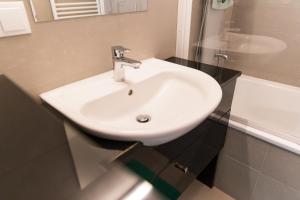 a white sink in a bathroom with a mirror at Design Place 1030 (airconditioned) in Vienna