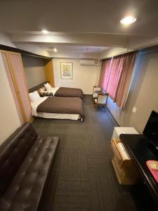 Postel nebo postele na pokoji v ubytování Hotel Yutaka Wing
