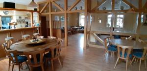 a dining room with a wooden table and chairs at Gasthof zum alten Schulmeister in Harra