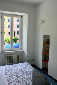 a bedroom with a bed and a window at Da Marcella in Vernazza