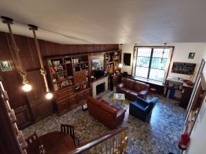 an overhead view of a living room with a couch and chairs at Mucha Masia Hostel Rural Urba in El Prat de Llobregat