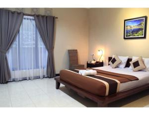 a bedroom with a large bed and a window at Pendopo 45 Resort in Bogor