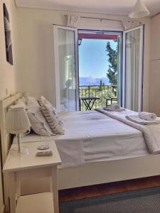 Postel nebo postele na pokoji v ubytování Gastouri Villa Pascalia with heated pool in October and views