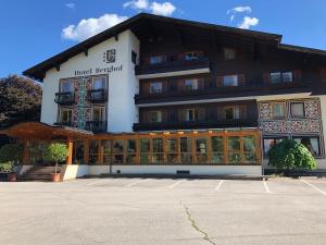 a building with a parking lot in front of it at Hotel Berghof in Berg im Drautal