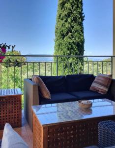 a living room with a couch and a table at Gastouri Villa Pascalia with heated pool in October and views in Achílleion