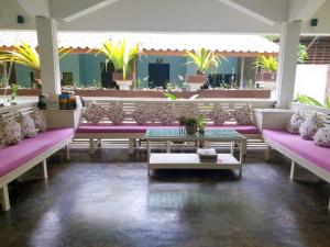 a room with purple benches and a table at Simple Life Resort Koh Tao in Koh Tao