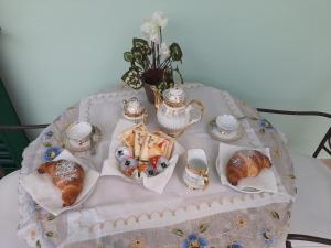 a table with a tray of pastries and tea sets at Gerry house in Amalfi