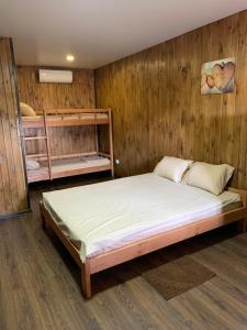 a bedroom with a bed and two bunk beds at Мини-отель Sunrise-Bugaz in Zatoka +51 photos