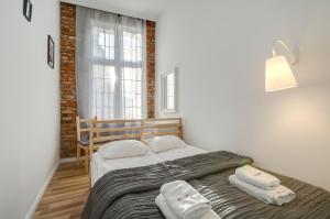 Posteľ alebo postele v izbe v ubytovaní Apartament Chlebnicka II