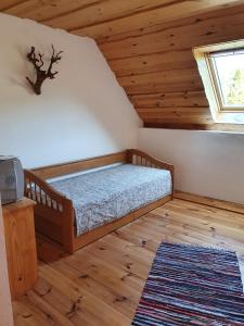 a bedroom with a bed in a attic at Penzión u Čupku in Mlynky 