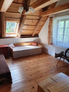a bedroom with a bed in a room with wooden ceilings at Penzión u Čupku in Mlynky 