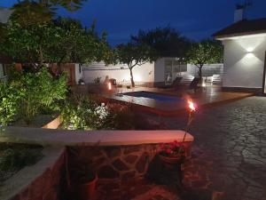 a backyard with a swimming pool at night at Dafne Home in Pompei