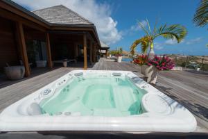a jacuzzi tub on the deck of a house at Dream Villa Marigot 771 in Saint Barthelemy