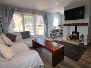 a living room with a couch and a fireplace at 2 Snape Hill in Dronfield