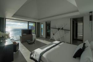a bedroom with a large bed and a television at Dream Villa Gustavia 701 in Gustavia