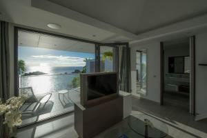 a living room with a television and a large window at Dream Villa Gustavia 701 in Gustavia